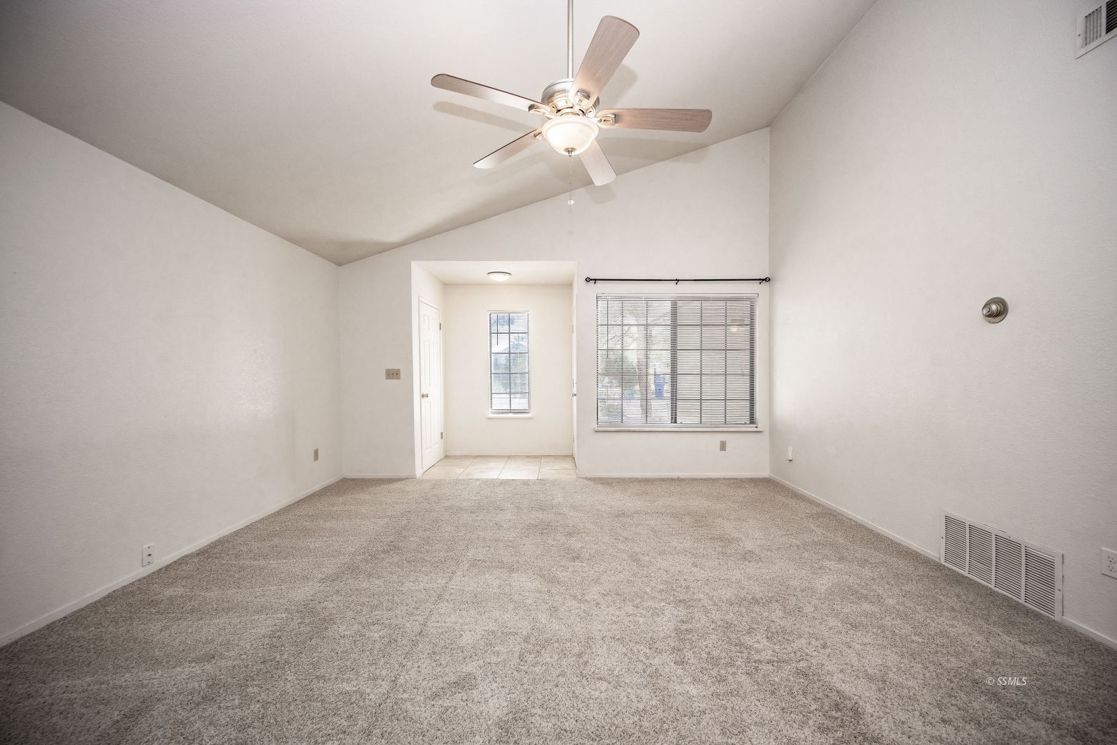704 Beth Lane Ridgecrest, CA 93555 - Photo 15 of 39 an empty room with chandelier fan and windows