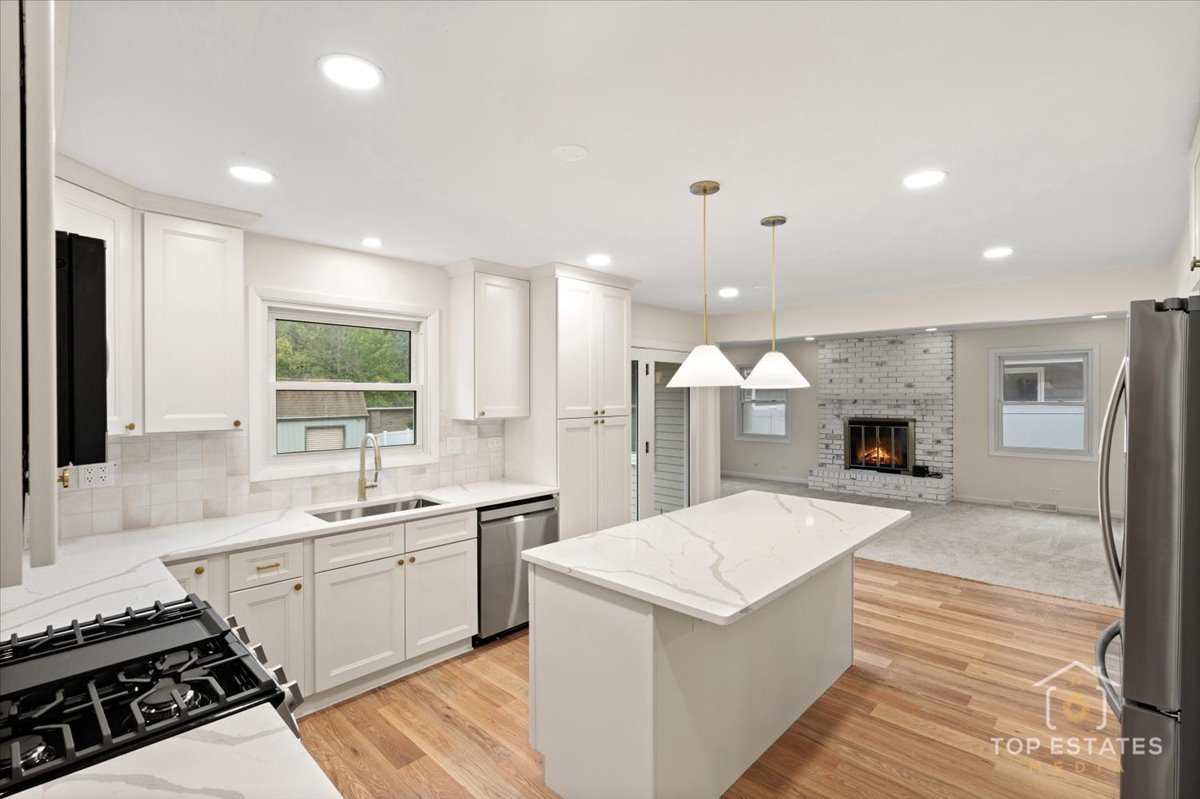 1408 Swallow Street Naperville, IL 60565 - Photo 11 of 54 a large kitchen with a stove and a sink