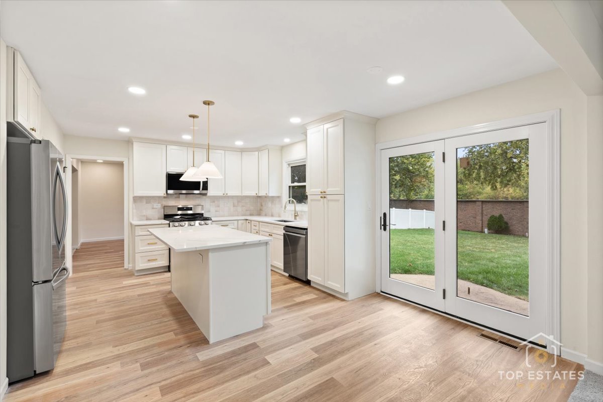 1408 Swallow Street Naperville, IL 60565 - Photo 13 of 54 a kitchen with stainless steel appliances kitchen island granite countertop a refrigerator a sink a stove and white cabinets with wooden floor