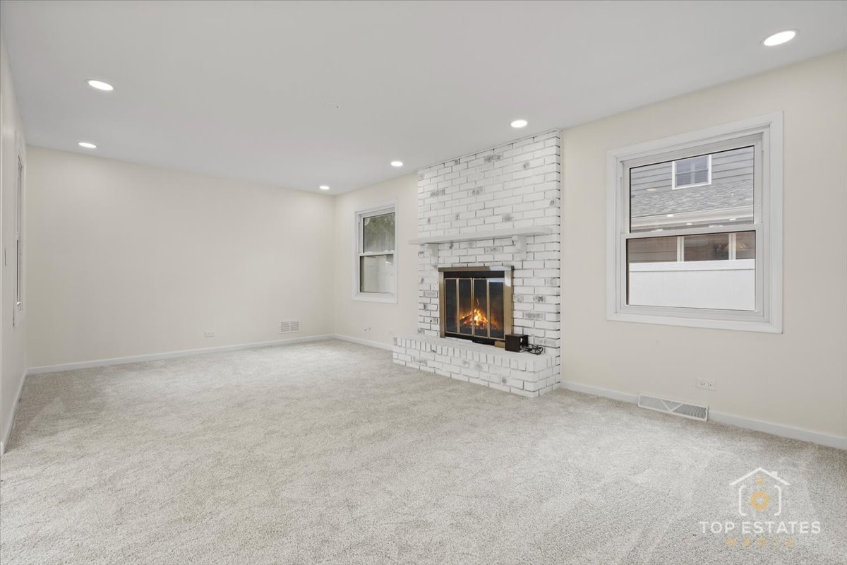 1408 Swallow Street Naperville, IL 60565 - Photo 17 of 54 an empty room with a fireplace and window