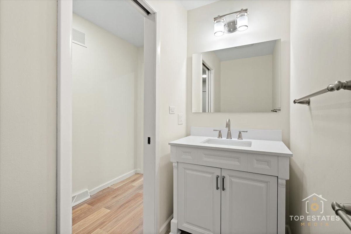 1408 Swallow Street Naperville, IL 60565 - Photo 20 of 54 a bathroom with a sink and a mirror