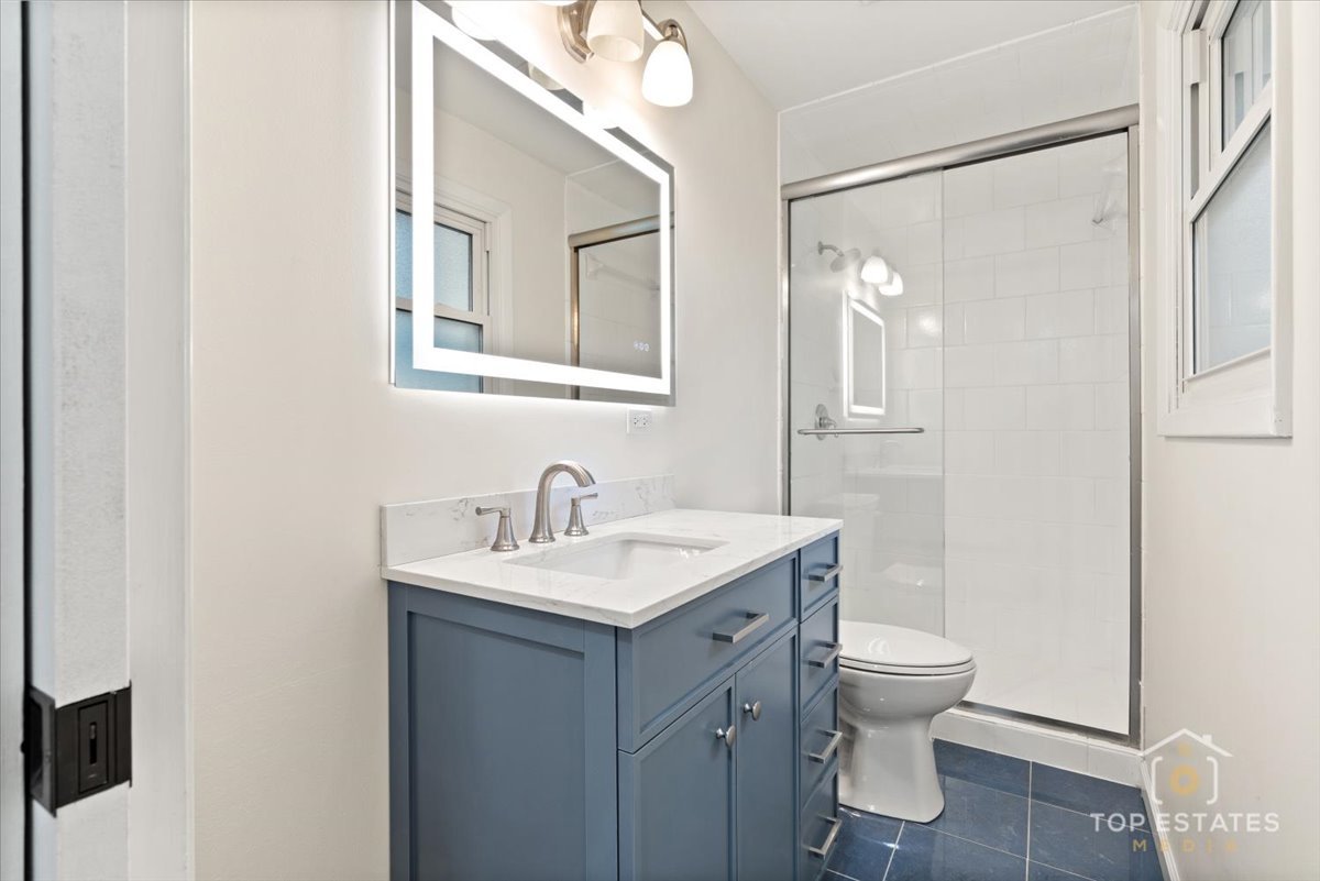 1408 Swallow Street Naperville, IL 60565 - Photo 23 of 54 a bathroom with a toilet sink and mirror