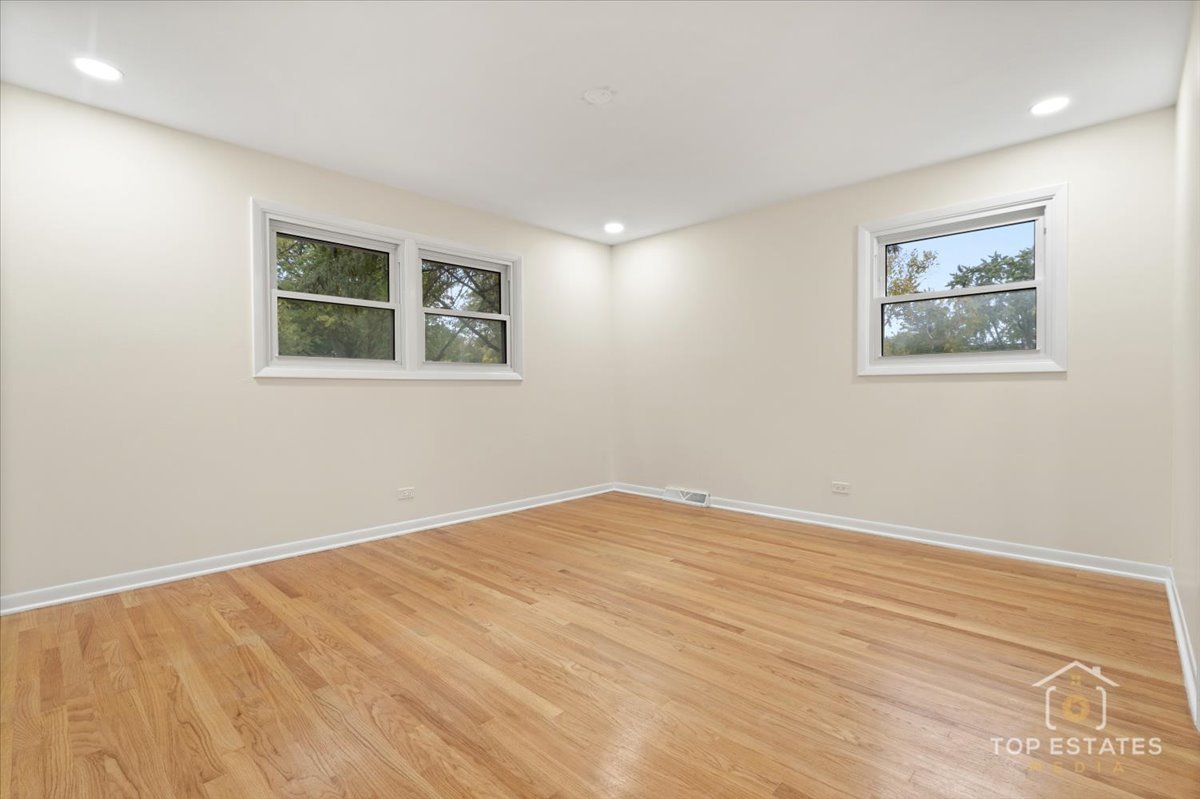 1408 Swallow Street Naperville, IL 60565 - Photo 28 of 54 a view of an empty room with wooden floor and a window