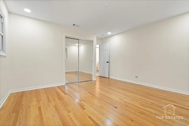 a bathroom with a granite countertop toilet sink and mirror