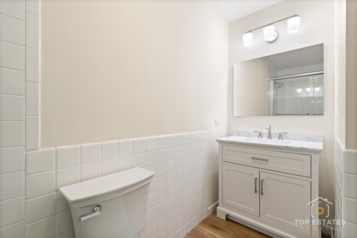 1408 Swallow Street Naperville, IL 60565 - Photo 30 of 54 a bathroom with a granite countertop toilet sink and mirror