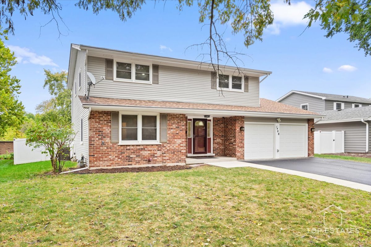 1408 Swallow Street Naperville, IL 60565 - Photo 3 of 54 a front view of a house with a yard