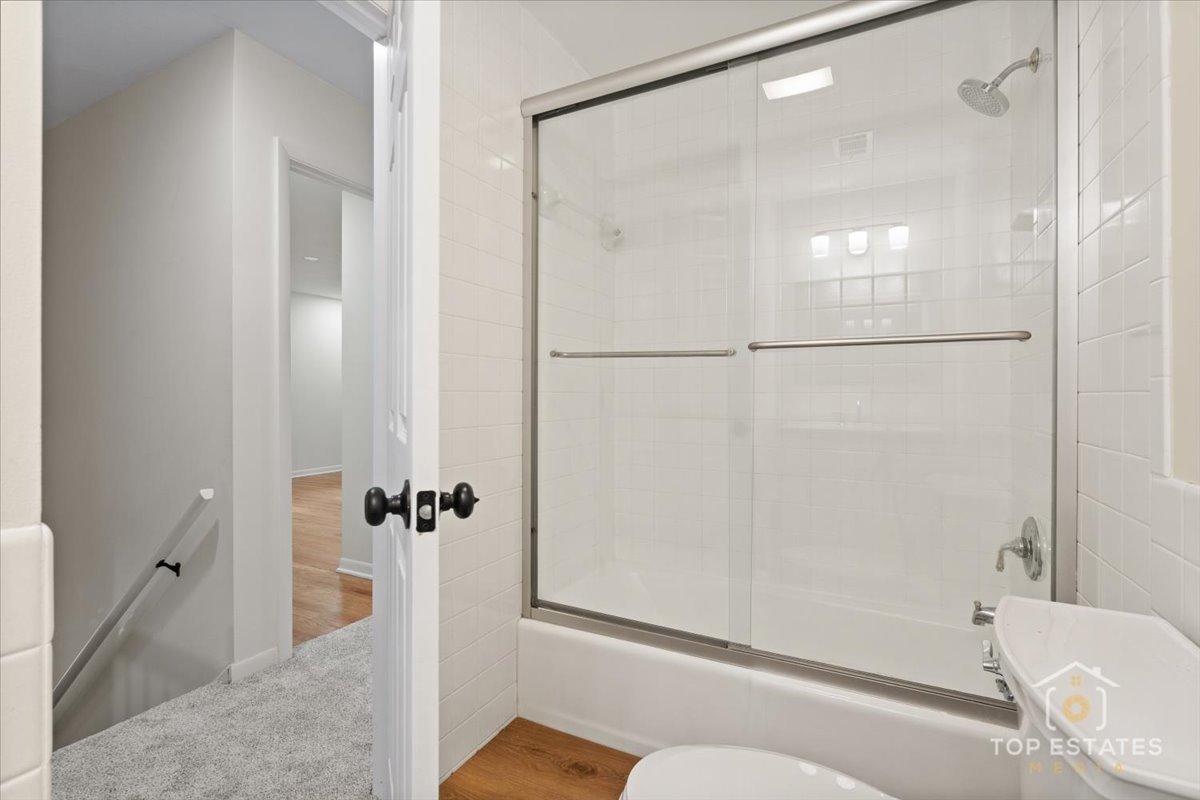 1408 Swallow Street Naperville, IL 60565 - Photo 31 of 54 a bathroom with a shower and a toilet