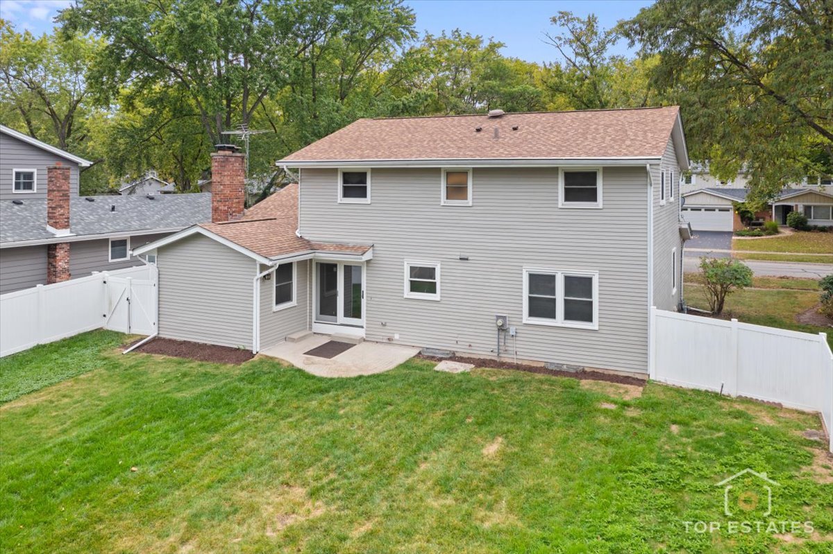 1408 Swallow Street Naperville, IL 60565 - Photo 35 of 54 a front view of a house with a yard and garage
