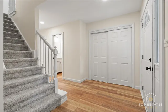 a view of entryway and hall with wooden floor
