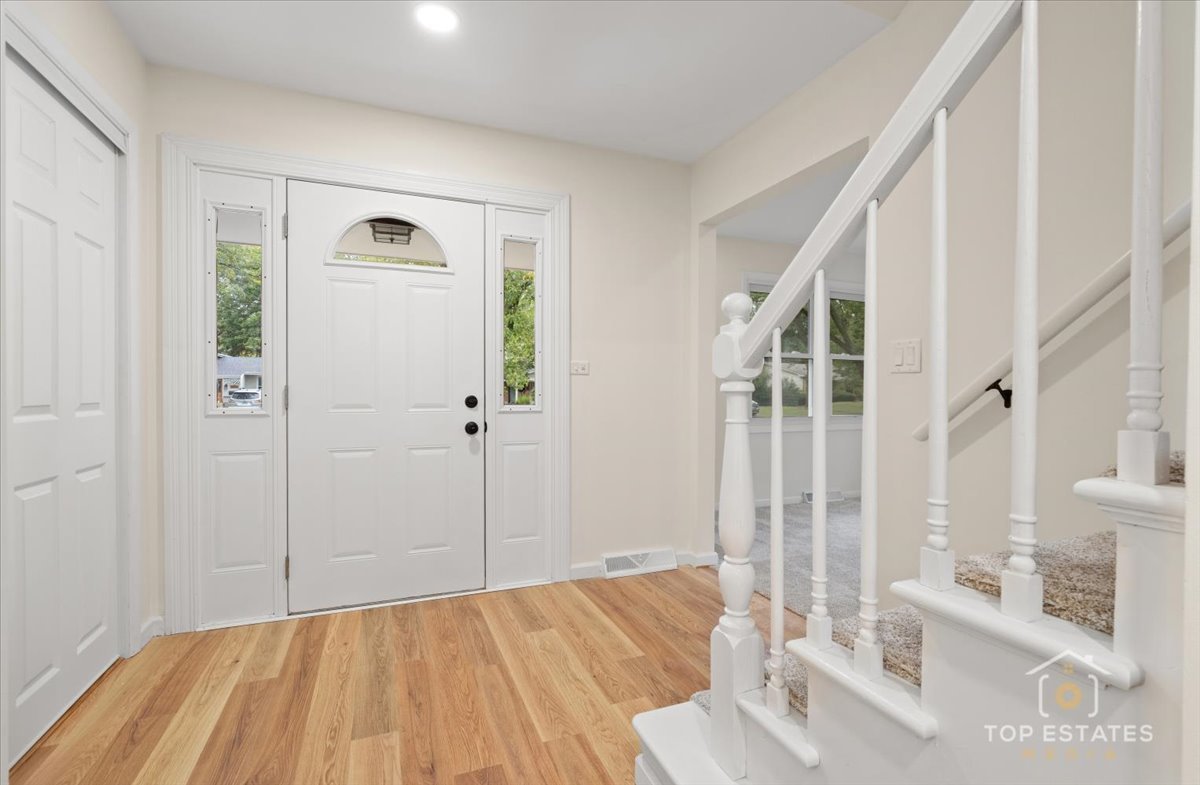 1408 Swallow Street Naperville, IL 60565 - Photo 5 of 54 a view of a bedroom with wooden floor and windows