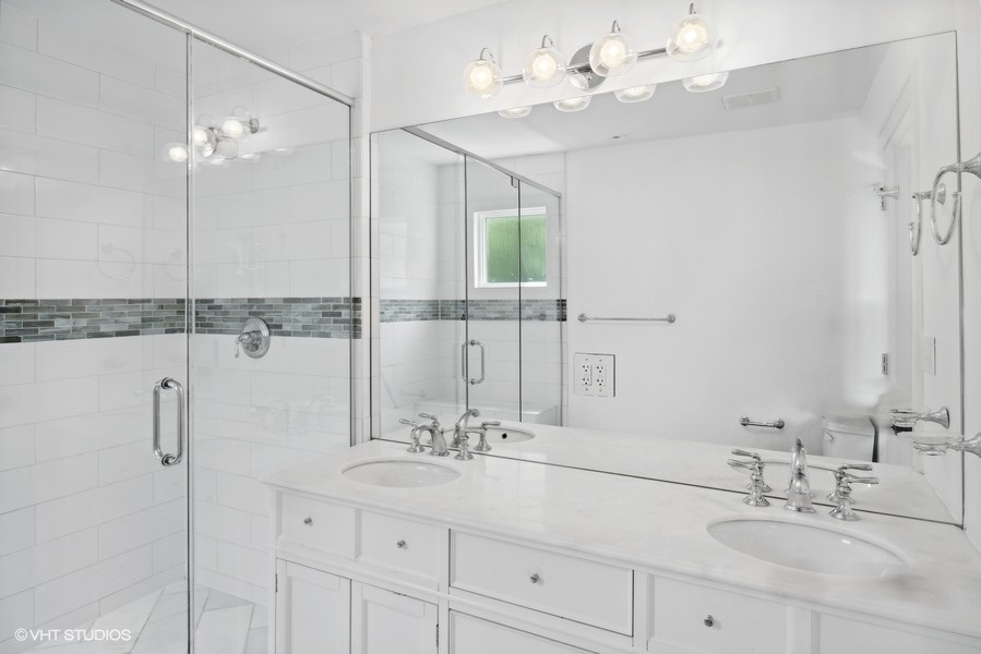 152 Bertling Lane Winnetka, IL 60093 - Photo 20 of 38 a bathroom with a double vanity sink and a mirror