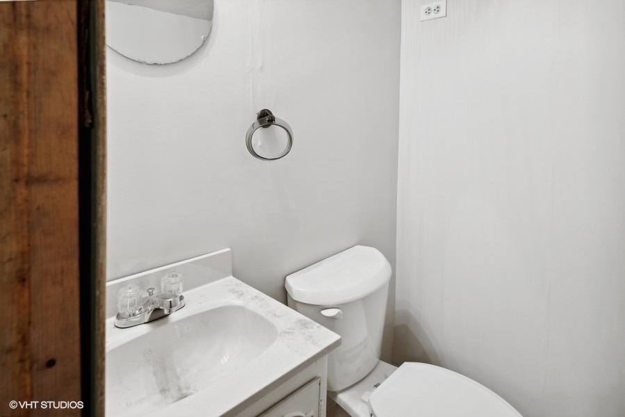 152 Bertling Lane Winnetka, IL 60093 - Photo 33 of 38 a white toilet sitting next to a bathroom sink