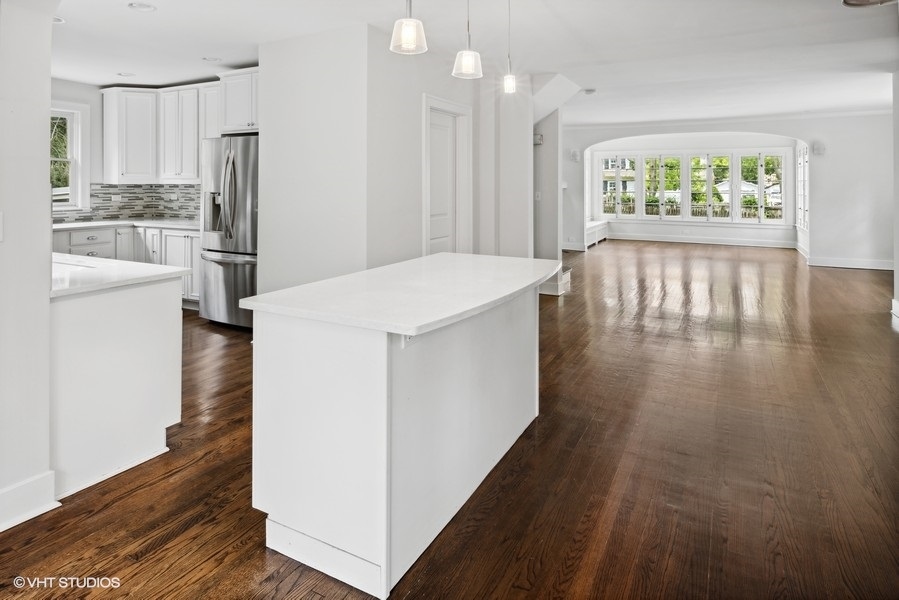 152 Bertling Lane Winnetka, IL 60093 - Photo 8 of 38 a kitchen with stainless steel appliances a refrigerator and wooden floor