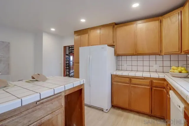 a kitchen with a sink and refrigerator
