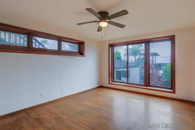 a view of a livingroom with a ceiling fan and window