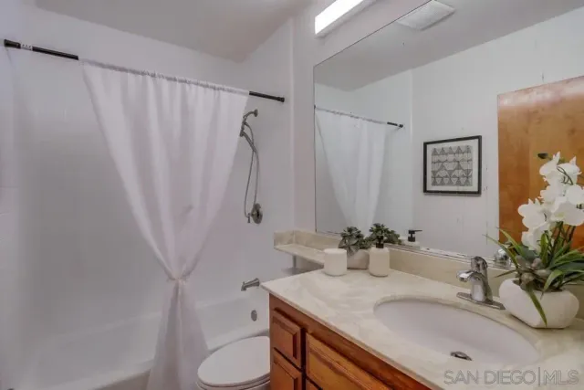 a spacious bedroom with a large bed and a large window