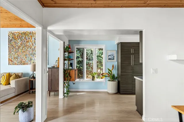 a view of living room filled with furniture and floor to ceiling window