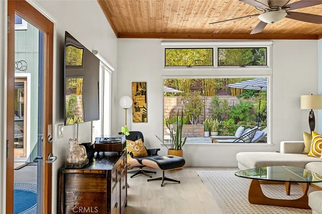 a living room with furniture and a floor to ceiling window