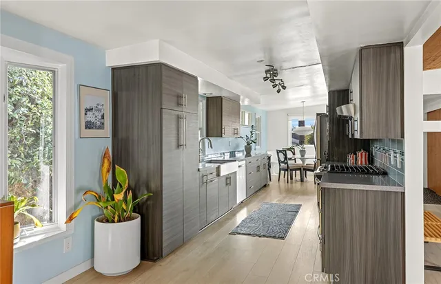 a kitchen with a refrigerator and a sink