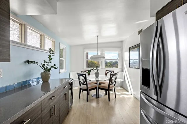 a dining room with furniture potted plants and wooden floor