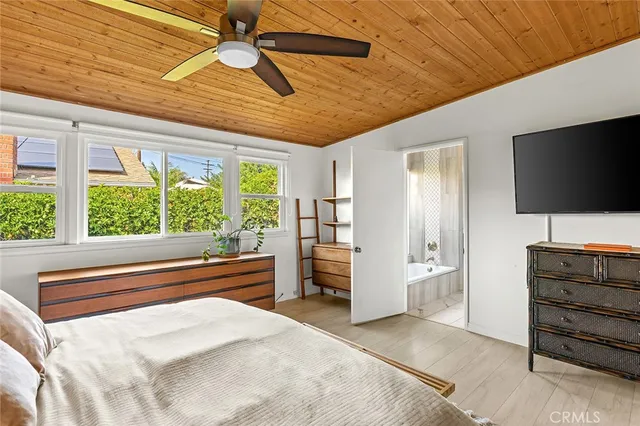 a bedroom with furniture and a flat screen tv