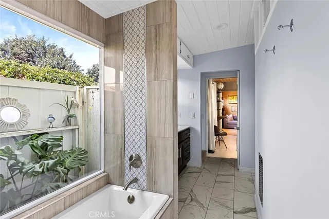 a bathroom with a tub and shower