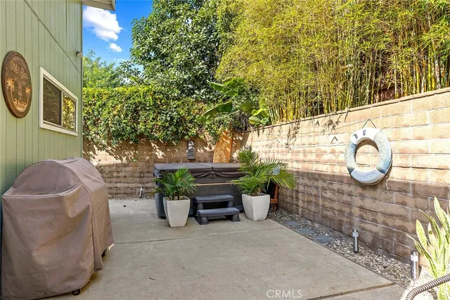 a backyard of a house with table and chairs