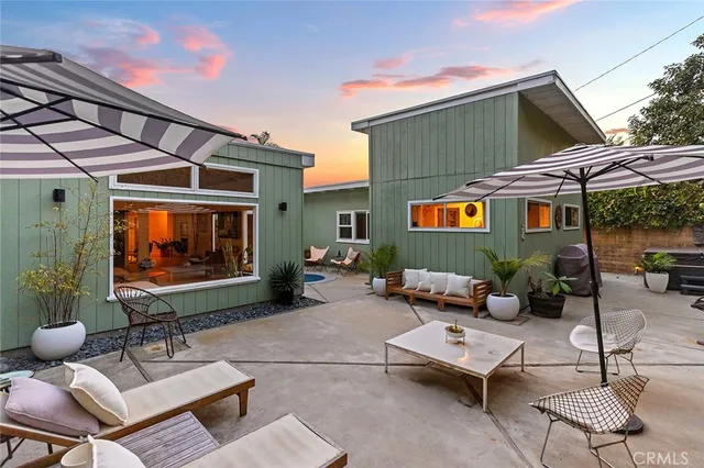 a building outdoor space with patio furniture and potted plants