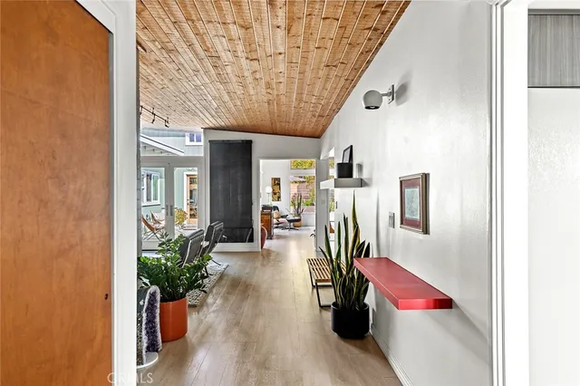 a hallway with wooden floor and furniture