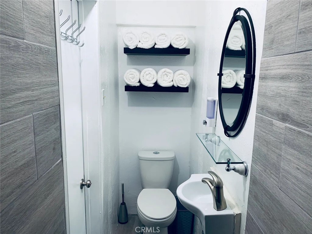15133 Bellflower Boulevard Bellflower, CA 90706 - Photo 15 of 16 a bathroom with a toilet and a sink