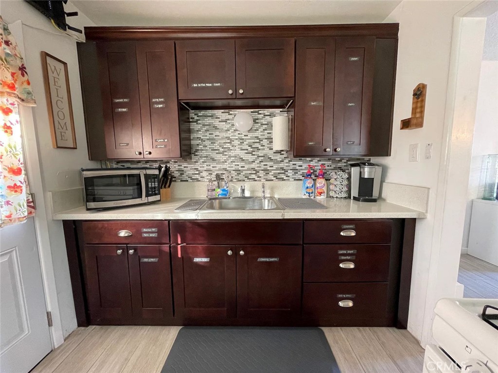 15133 Bellflower Boulevard Bellflower, CA 90706 - Photo 5 of 16 a bathroom with a sink vanity and a mirror