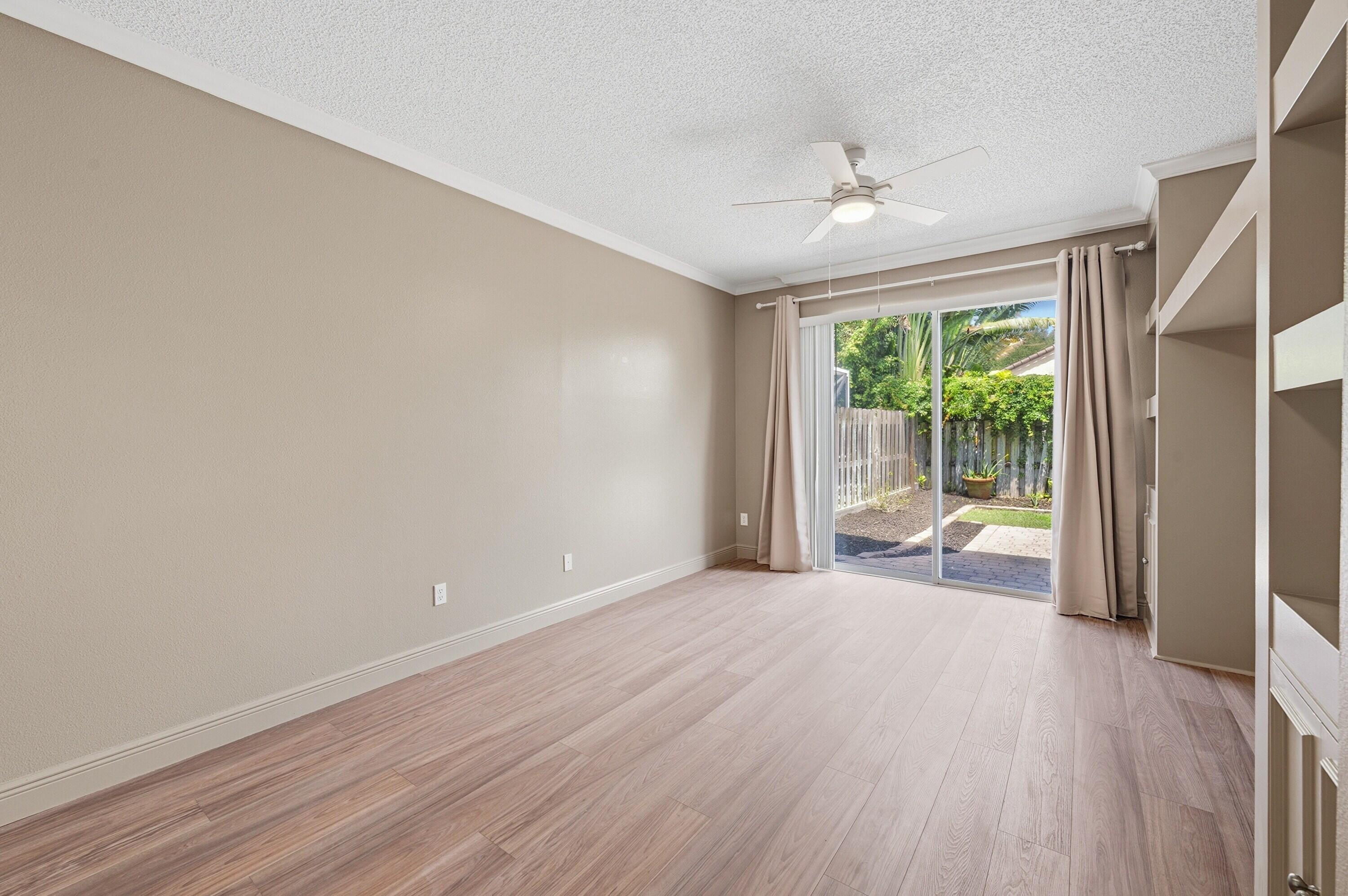 18474 Old Princeton Lane Boca Raton, FL 33498 - Photo 21 of 46 a view of an empty room with wooden floor and a window