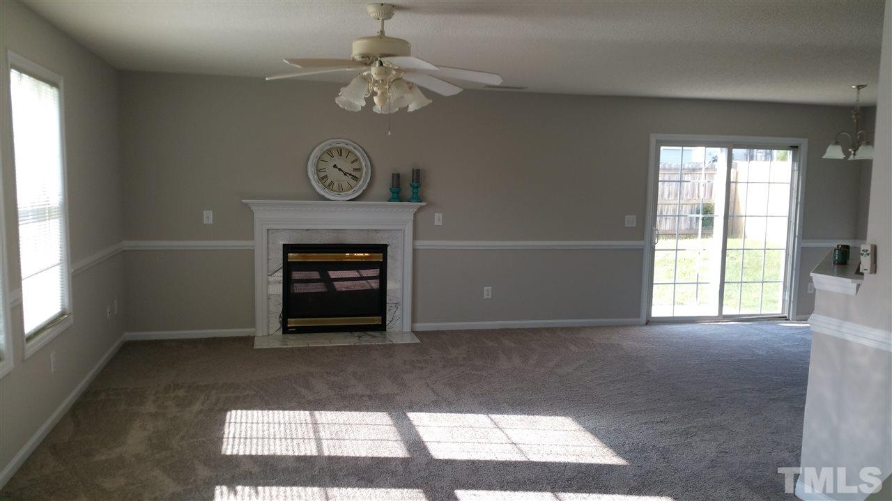 4301 Standing Rock Way Raleigh, NC 27604 - Photo 2 of 22 a view of an empty room with a fireplace and a window