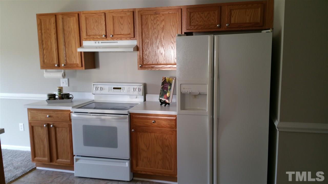 4301 Standing Rock Way Raleigh, NC 27604 - Photo 4 of 22 a kitchen with stainless steel appliances granite countertop a refrigerator and a stove top oven
