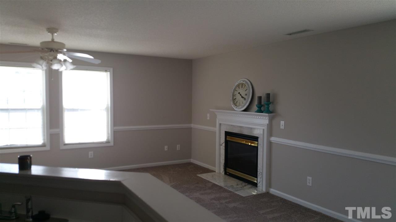 4301 Standing Rock Way Raleigh, NC 27604 - Photo 6 of 22 a view of an empty room with a fireplace and a window