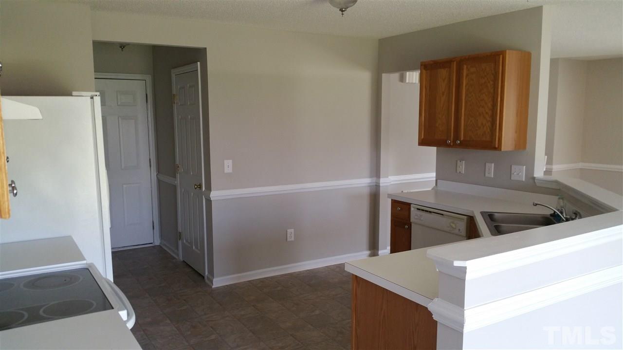 4301 Standing Rock Way Raleigh, NC 27604 - Photo 8 of 22 a kitchen with a refrigerator and a stove top oven