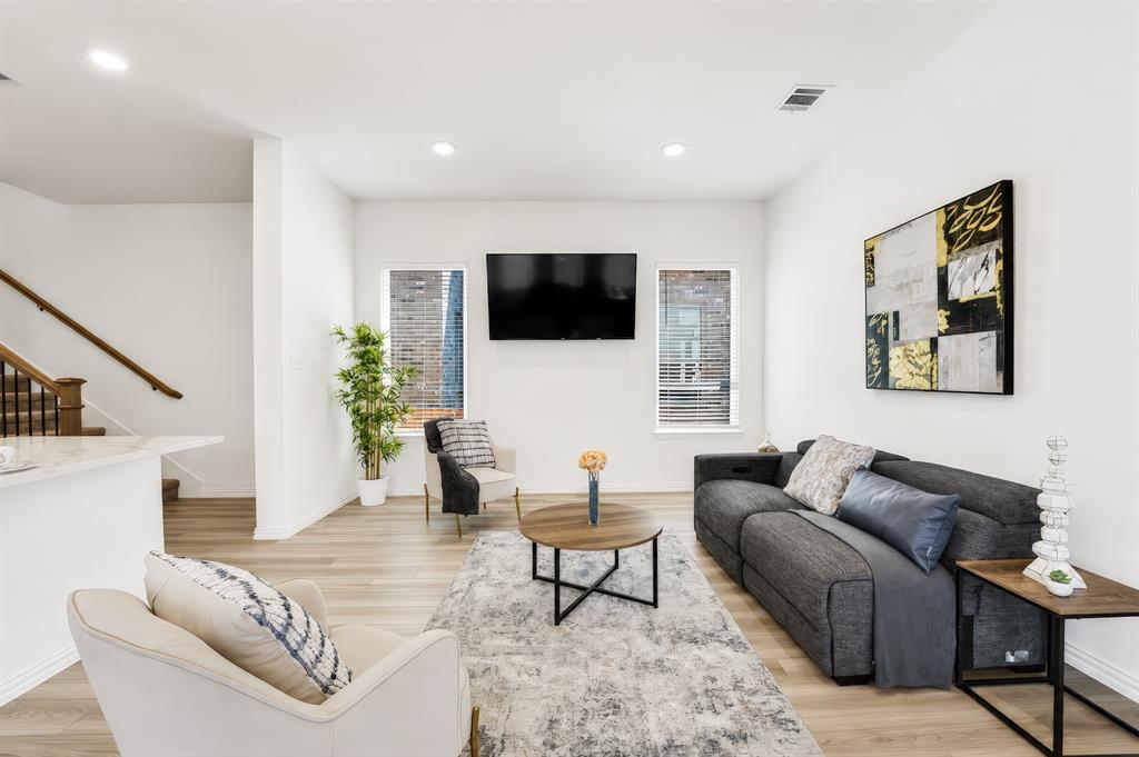 3610 Scotsman Road Sachse, TX 75048 - Photo 5 of 34 Recessed lighting illuminates the open living space with wood-finish flooring