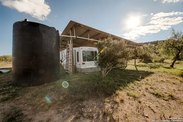 a room with gym equipment and large windows