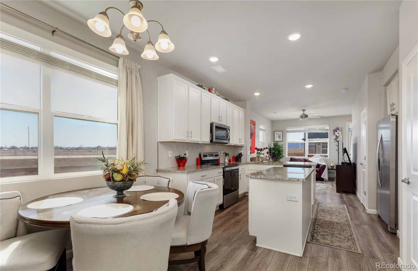 Undisclosed Address Berthoud, CO 80513 - Photo 12 of 26 a kitchen with a table chairs stove and microwave