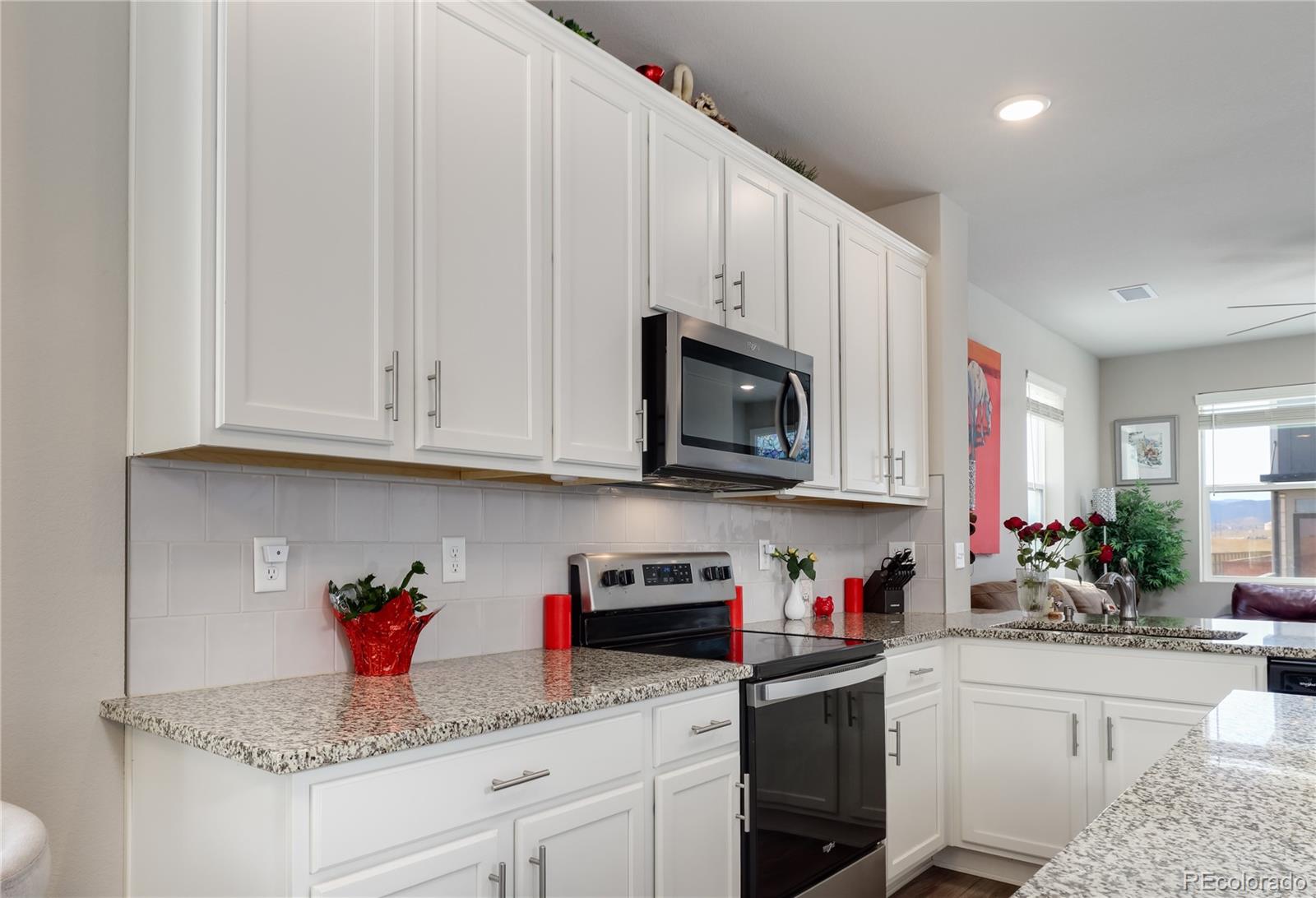 Undisclosed Address Berthoud, CO 80513 - Photo 8 of 26 a kitchen with stainless steel appliances granite countertop white cabinets sink and dishwasher with wooden floor