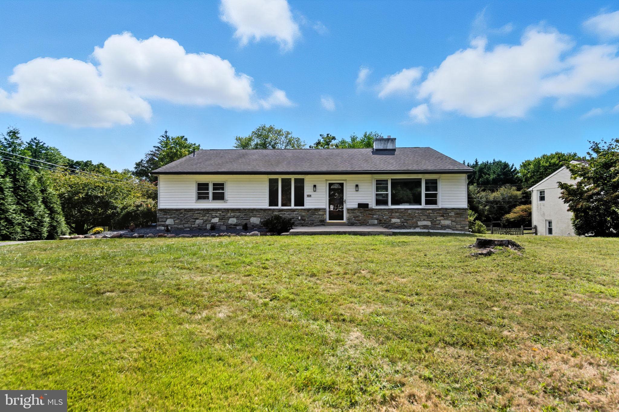a front view of a house with swimming pool having outdoor seating