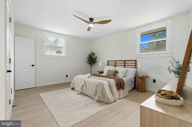 a bedroom with two beds and a window