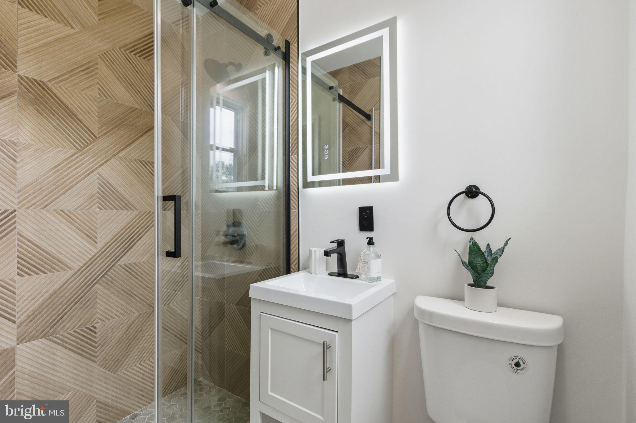 151 Dolington Road Yardley, PA 19067 - Photo 14 of 39 a bathroom with a toilet a sink and mirror