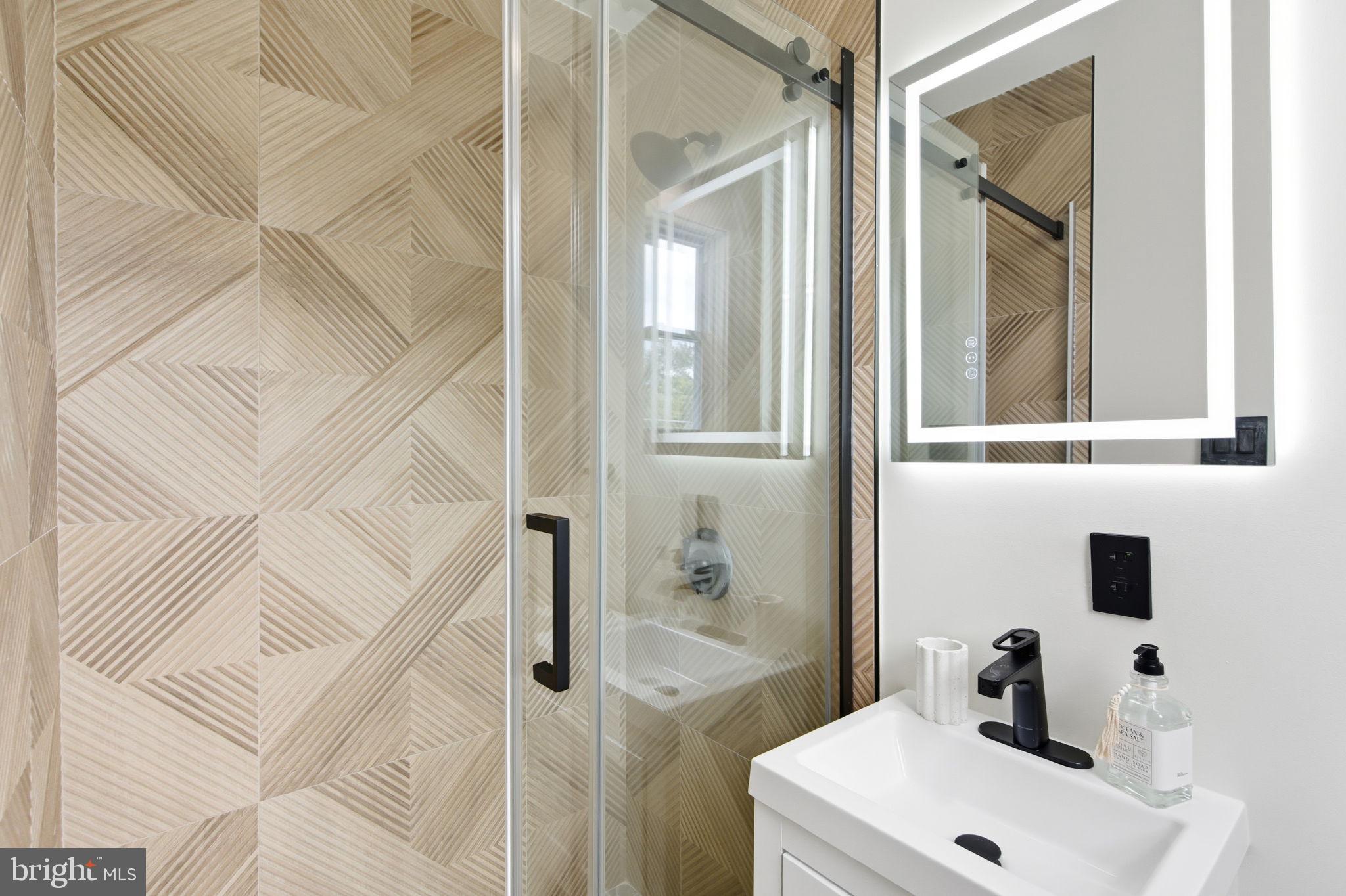 151 Dolington Road Yardley, PA 19067 - Photo 15 of 39 a bathroom with a sink a mirror and shower