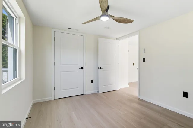 a large white kitchen with white cabinets