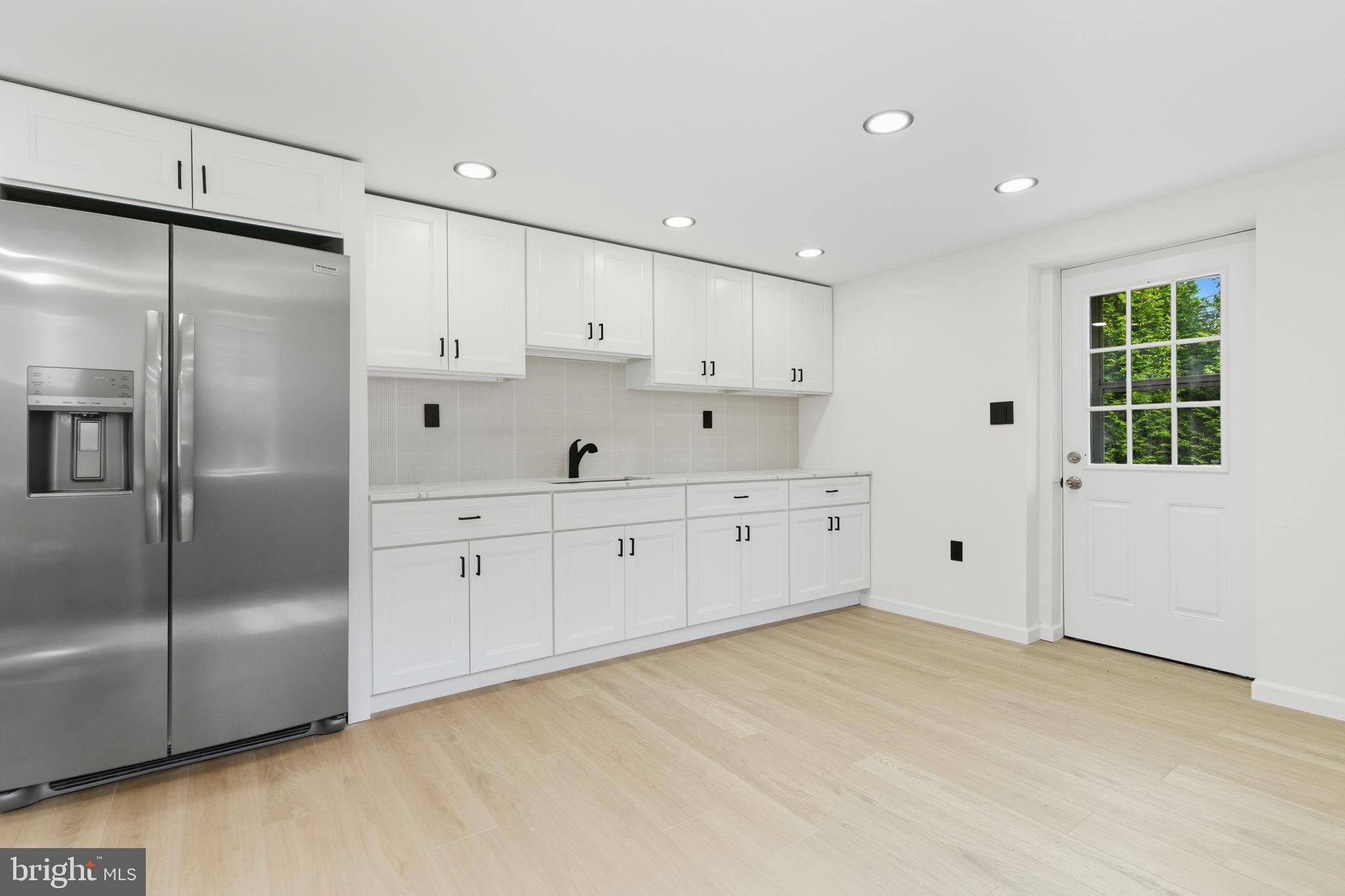 151 Dolington Road Yardley, PA 19067 - Photo 29 of 39 a large white kitchen with white cabinets