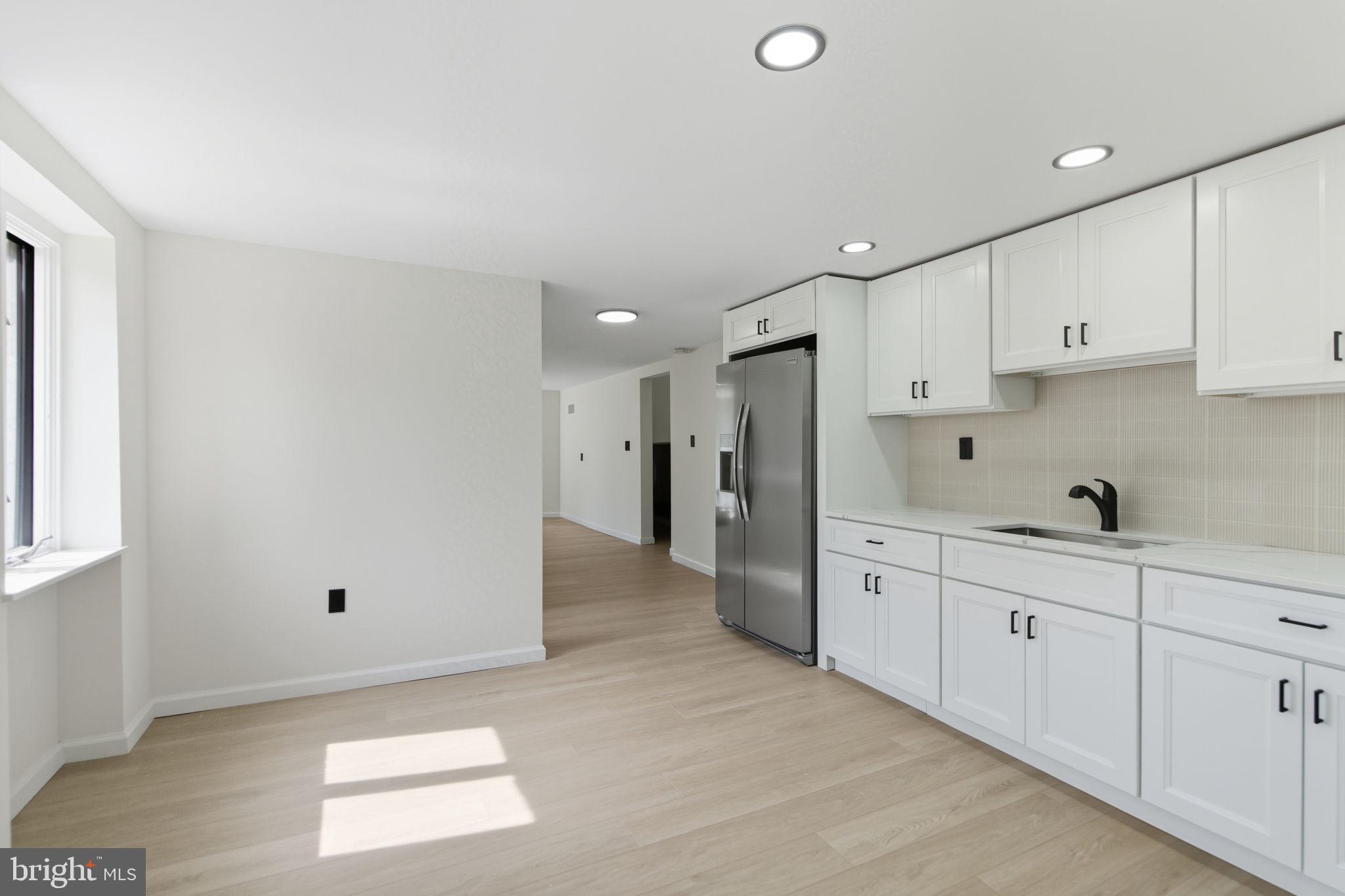 151 Dolington Road Yardley, PA 19067 - Photo 30 of 39 a view of a kitchen with refrigerator and white cabinets