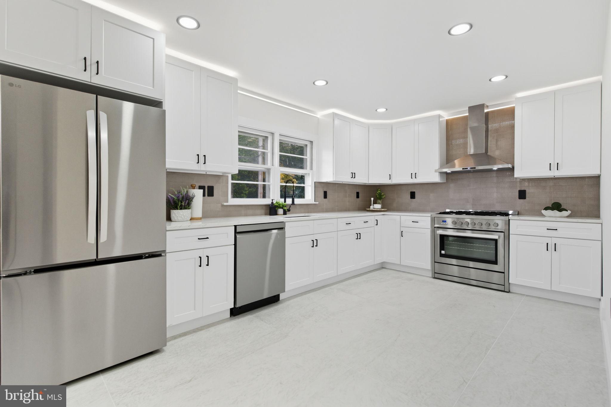 151 Dolington Road Yardley, PA 19067 - Photo 9 of 39 a kitchen with white cabinets stainless steel appliances and sink