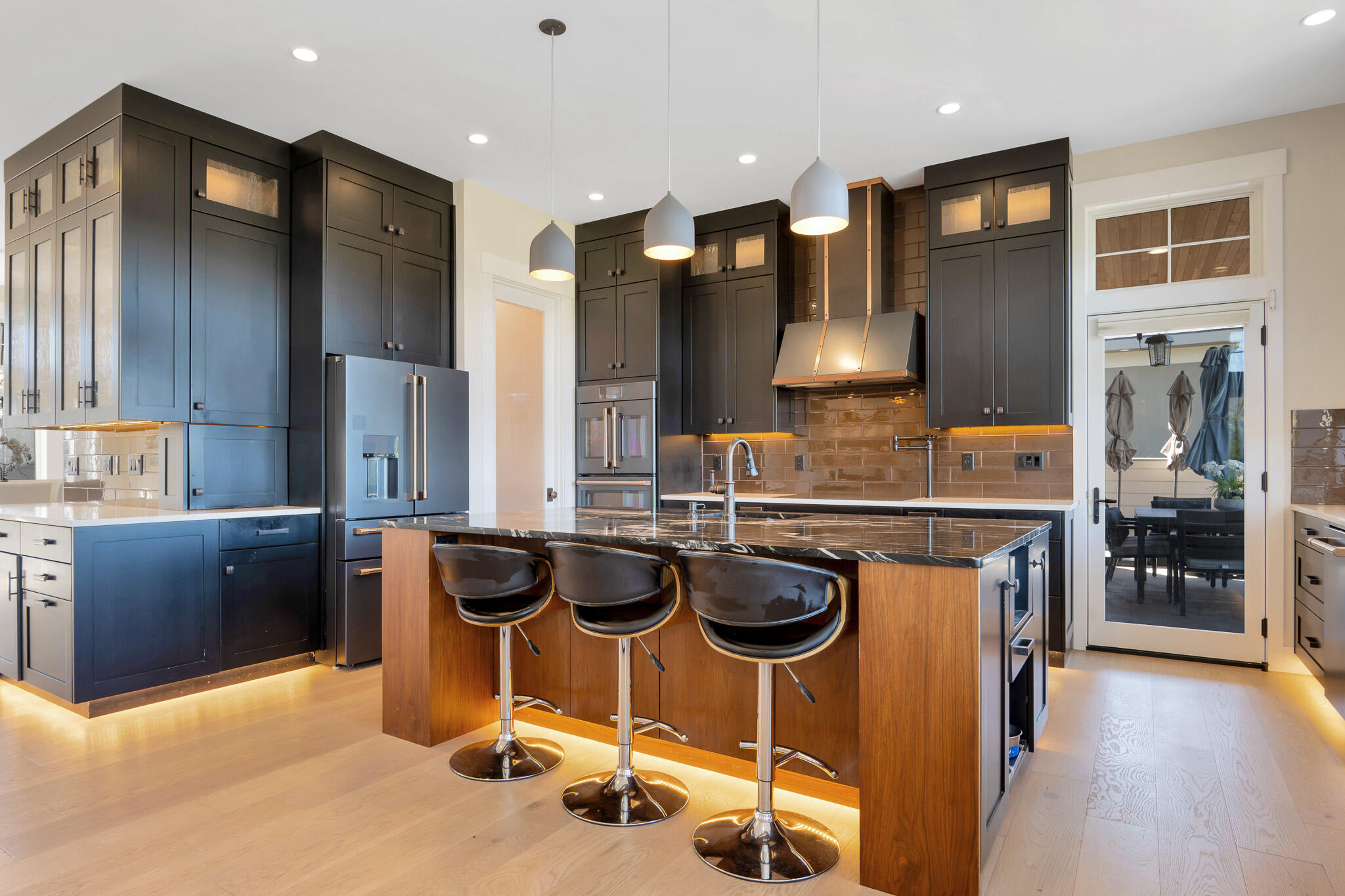 60871 River Rim Drive Bend, OR 97702 - Photo 12 of 42 a kitchen with a table chairs refrigerator and cabinets