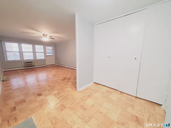 an empty room with a empty space and windows
